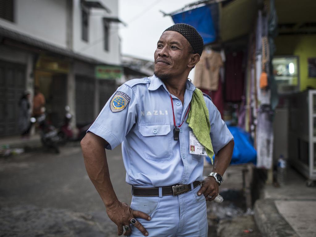 A traffic controller poses in the street in Banda Aceh, Indonesia. Picture by Matt Turner.