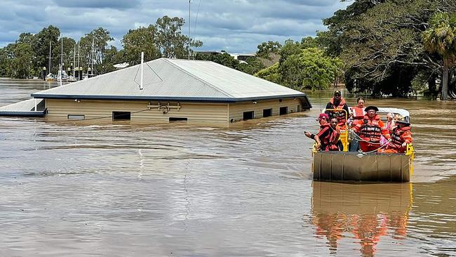 Rescuers on a boat evacuating people along a flooded street in Maryborough in Queensland. (Photo by Handout / QUEENSLAND FIRE AND EMERGENCY SERVICES / AFP)