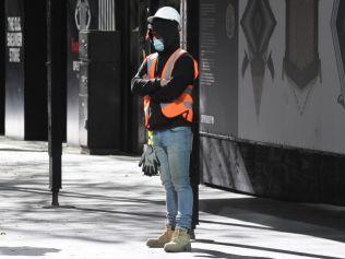 SYDNEY, AUSTRALIA - JULY 17: A construction worker outside his work site in the CBD on July 17, 2021 in Sydney, Australia. Lockdown restrictions have been further tightened as NSW continues to record new community COVID-19 cases and works to stop the spread of the highly infectious delta coronavirus strain in the community. New rules which will come into effect at midnight on Saturday across Greater Sydney including the Central Coast, Blue Mountains, Wollongong and Shellharbour require all non-essential retail to close. Businesses can still operate click and collect, takeaway and home delivery. In addition to stay at home orders, residents in the local government areas of Fairfield, Canterbury-Bankstown and Liverpool cannot leave their areas for work except for emergency services and healthcare workers. Where those workers do need to leave their local government area for work, they are required to be tested every three days, even if they do not have symptoms. Residents of Greater Sydney, the Blue Mountains, the Central Coast and Wollongong are subject to stay-at-home orders with people are only permitted to leave their homes for essential reasons. Essential reasons include purchasing essential goods, accessing or providing care or healthcare, essential work, education or exercise. Exercise is restricted to within the local government area and no further than 10km from home and with a maximum of two people per group. Browsing in shops is prohibited and only one person per household can leave home for shopping per day. Outdoor public gatherings are limited to two people, while funerals are limited to 10 people only. The restrictions are expected to remain in place until 11:59 pm on Friday 30 July. (Photo by James D. Morgan/Getty Images)