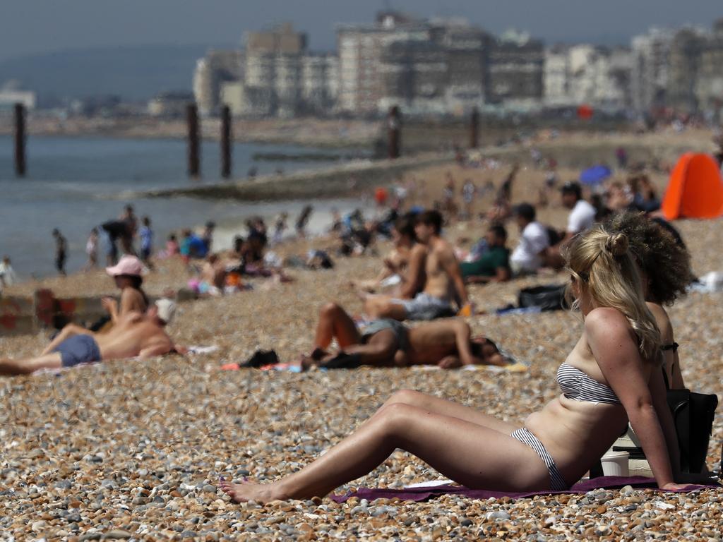 People sunbathe on a beach in Brighton, England. Lockdown restrictions have been relaxed allowing unlimited outdoor exercise and activities such as sunbathing. Picture: AP Photo
