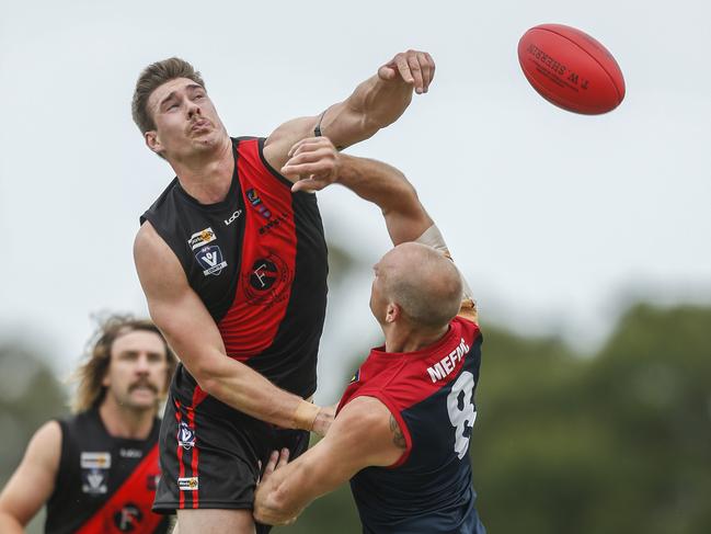 Frankston Bomber Harry Prior wins a hit out against Mt Eliza’s Shane Tennant.