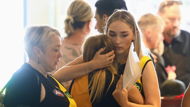 Samara Laverty and Bridget Laverty hug family at the funeral of Declan Laverty. Mr Laverty, 20, was stabbed to death while working at a Darwin bottle shop. Picture: Brendan Radke