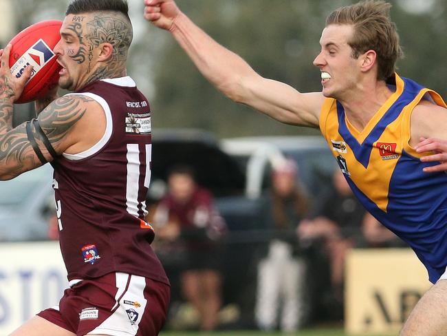 Hugo Papst tries to get the ball off a Melton player last year. He had the last laugh on Saturday, kicking three late goals to help his team win. Picture: Hamish Blair