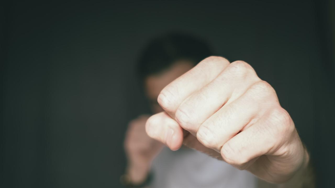 A Queensland man with a long history of drunken violence punched friend of his mother in the face five times, all while right outside a police station.