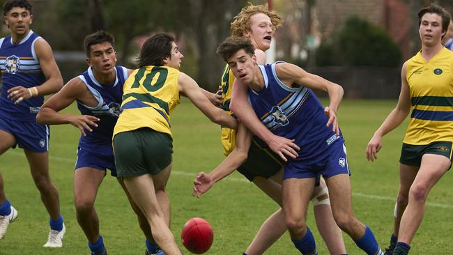 James McIntyre is tackled by Raphael Baker in the clash between Pembroke and Sacred Heart on Saturday. Picture: Matt Loxton