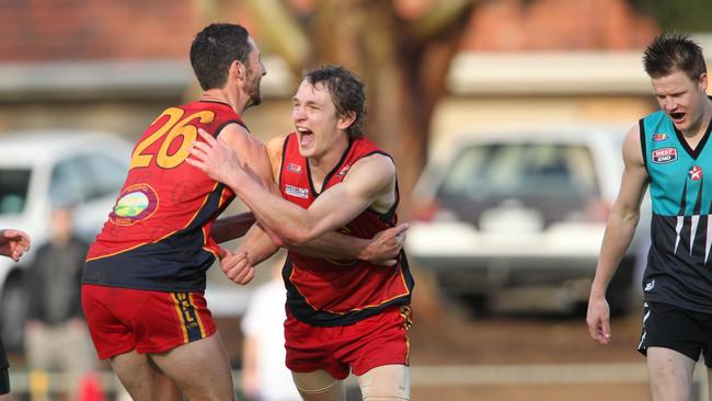 Joel Baldwin (right) celebrating a goal for Flinders Park in the 2011 division three grand final. Baldwin topped the league’s goal kicking for round 12 with a bag of 13 majors.