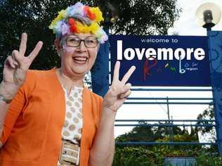 FEEL THE LOVE: Lismore Mayor Jenny Dowell beside a ‘welcome to Lismore’ – err, ‘lovemore’ – sign on the Ballina Rd roundabout outside The Northern Star’s Goonellabah offices. Lismore Council will not be changing the signs around Lismore - that's just a bit of digital mischief from us. Picture: Patrick Gorbunovs Digital Mischief Isobel Rodgers