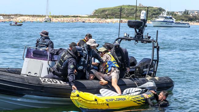 NSW Police stop climate protesters who paddled out to the shipping channel during the People's Blockade on November 24, 2024 in Newcastle (Photo by Roni Bintang/Getty Images)