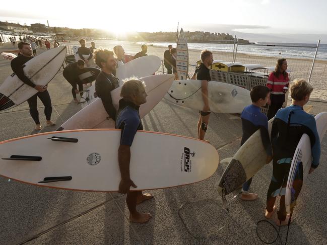 Surfers wait for officials to open Bondi Beach in Sydney. Picture: AP