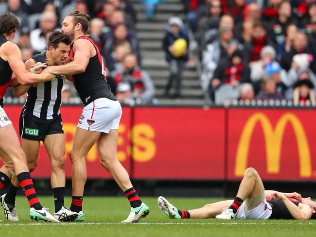 Joe Daniher and Cale Hooker remonstrate with Levi Greenwood after his high elbow on Zach Merrett. Picture: Getty Images