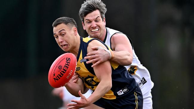 NFL: Hurstbridge’s William Cookson under the pump from Michael Naldrett of Northcote Park. Picture: Andy Brownbill