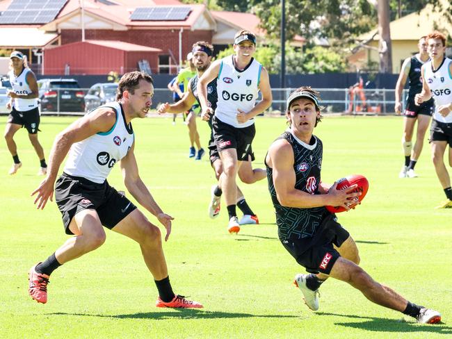 New Port Adelaide captain Connor Rozee getting chased by Francis Evans. Picture: Russell Millard Photography