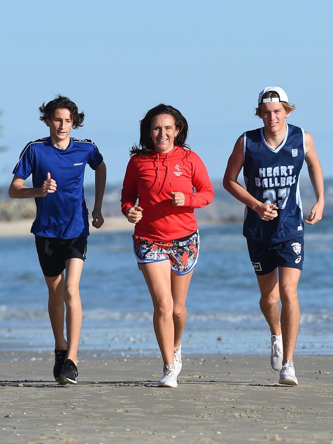 Anna Liptak with her sons Lachy, 14, and Zach, 16, at Glenelg. Picture: Naomi Jellicoe