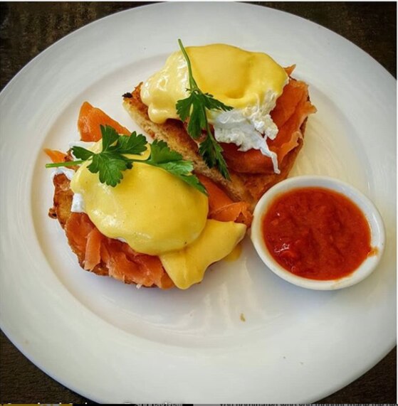 The streetside eatery in Taringa Place of Stones serves a classic Eggs Benny. Picture Instagram/placeofstones