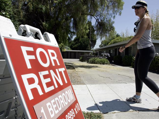 FILE - In this July 19, 2006 file photo, a woman walks next to a "For Rent" sign at an apartment complex in Palo Alto, Calif. Real estate data firm Zillow reports on U.S. home rental prices in December 2014 on Friday, Jan. 23, 2015. (AP Photo/Paul Sakuma, File)