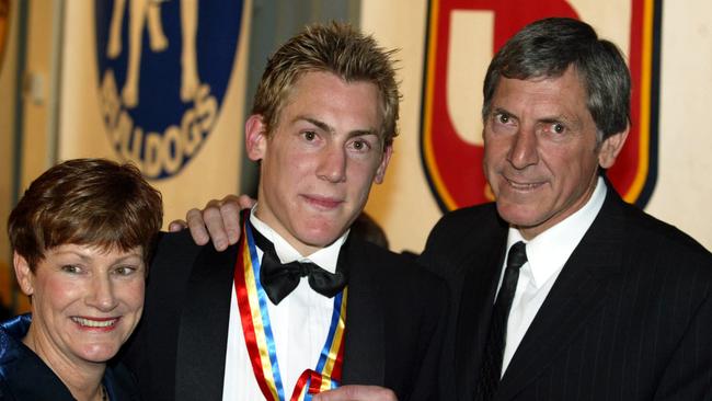 Brett Ebert (centre with mother Dian and father Russell after winning the Magarey Medal in 2003.