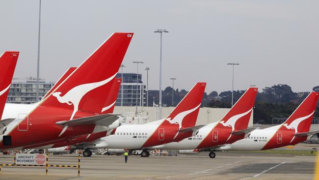 The tails of Qantas planes are lined up at Sydney Airport in Sydney, Sunday, Oct. 30, 2011. Qantas Airways grounded all of its aircraft around the world indefinitely Saturday due to ongoing strikes by its workers. (AP Photo/Rick Rycroft)