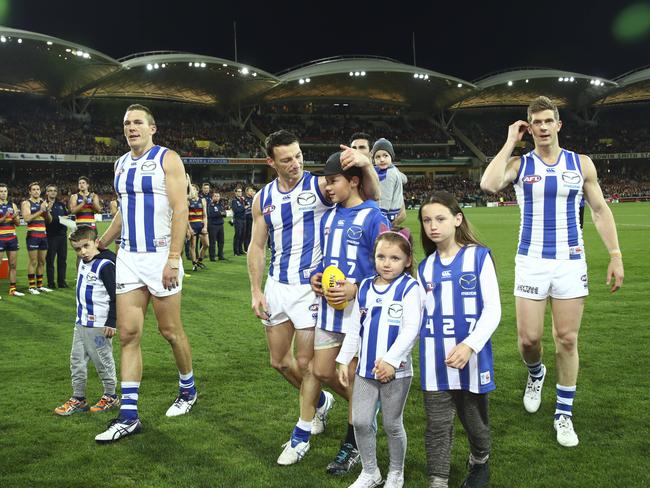 North Melbourne players Drew Petrie, Brent Harvey, Nick Dal Santo and Michael Firrito walk from the field after their final game in 2016. Picture Sarah Reed