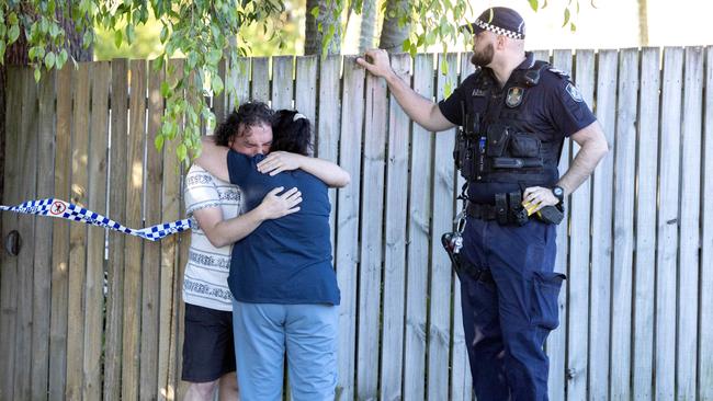 A man and woman console each other at the scene of the fatal shooting. Picture: Richard Walker