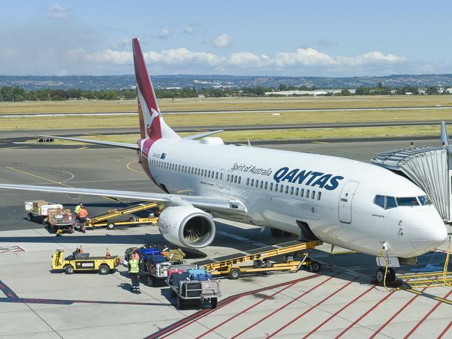 Qantas airport baggage handlers wearing protective gear while the supervisor (Not Sure) but looks as if he was giving orders was not wearing any protective gear at all and was not practising safe distance rules.Thursday April 2 2020.PIC SUPPLIED