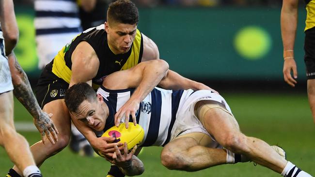 Dion Prestia tackles Joel Selwood during the qualifying final.