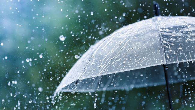 Transparent umbrella under heavy rain against water drops splash background. Rainy weather concept.Picture:Istock