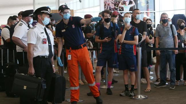 Passengers and airline crew arriving from Brisbane at Adelaide Airport are directed to the COVID-19 processing station. Picture: NCA NewsWire / Emma Brasier