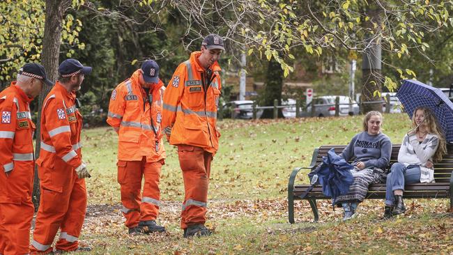 SES personnel conduct a fresh line search in Fawkner Park on Sunday as park users look on. Picture: Wayne Taylor