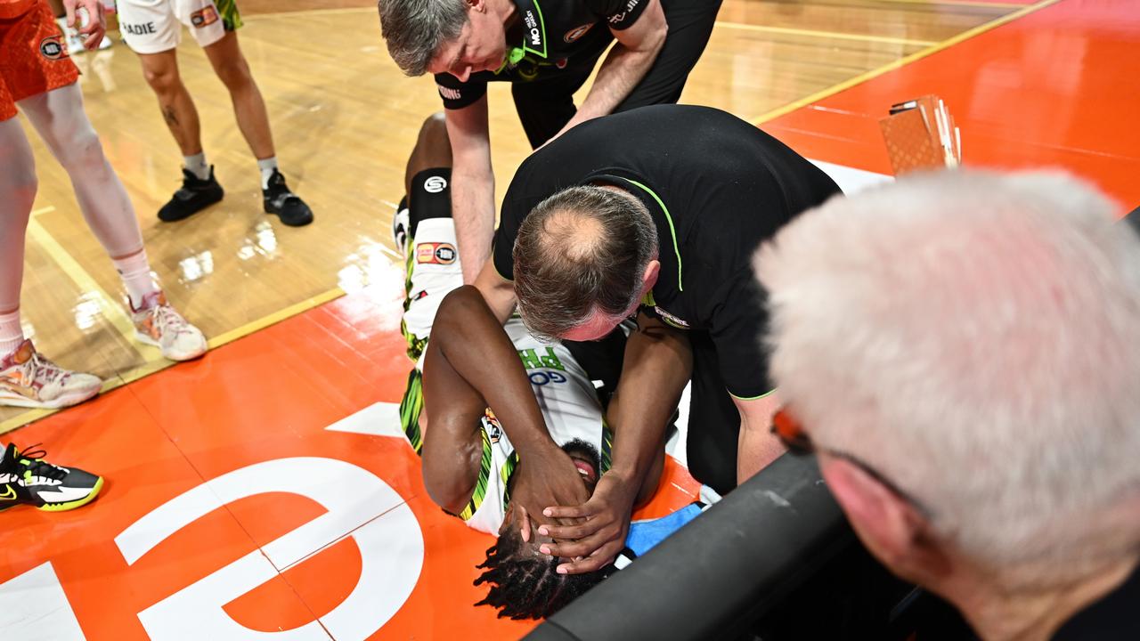 Phoenix head coach Mike Kelly attends to an injured Tyler Cook. Picture: Emily Barker/Getty Images