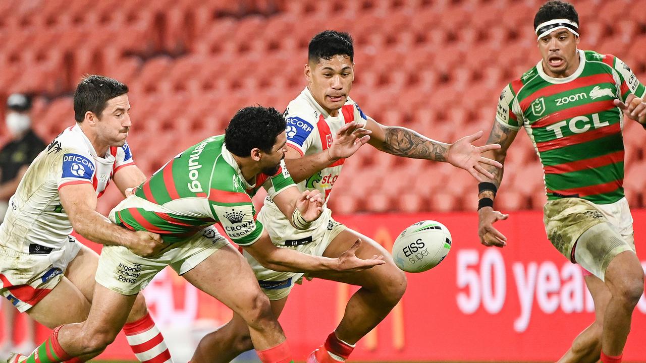 Walker sweetly offloads to Dane Gagai despite pressure from his Dragons opponents in Round 20 this year.