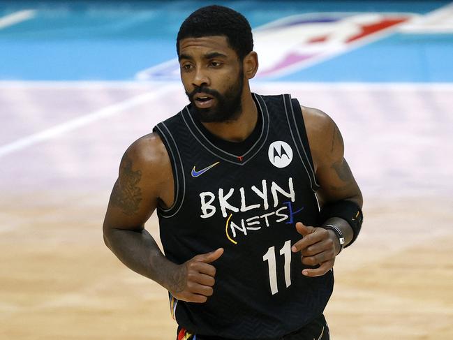 (FILES) In this file photo taken on December 27, 2020 Kyrie Irving #11 of the Brooklyn Nets runs the court during the fourth quarter of their game against the Charlotte Hornets at Spectrum Center in Charlotte, North Carolina. - Brooklyn point guard Kyrie Irving, who has been staunchly against getting vaccinated for the coronavirus, missed the Nets' practice on October 5, 2021. (Photo by Jared C. Tilton / GETTY IMAGES NORTH AMERICA / AFP)