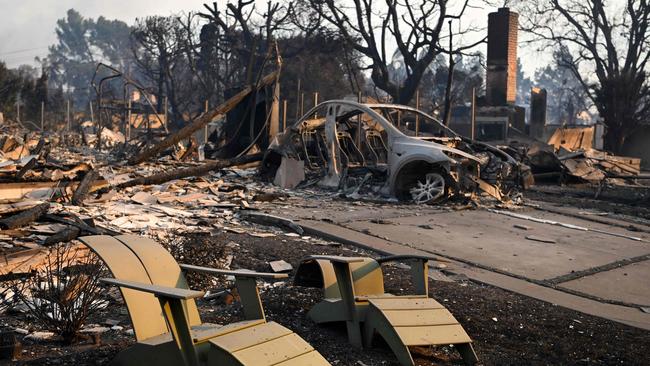 Melted lawn chairs are seen near the remains of a burnt home after the passage of the Palisades Fire in Pacific Palisades, California. Picture: AFP