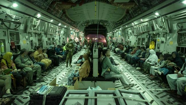 Families on-board the Royal Australian Air Force C-17A Globemaster. Picture: AFP PHOTO / AUSTRALIAN DEFENCE FORCE