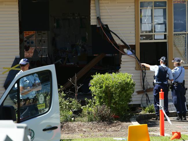 Police investigate the scene after the car is taken away. Picture: Jonathan Ng