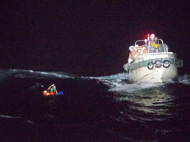 TOPSHOT - This handout picture taken on September 2, 2020 and provided by 10th Regional Coast Guard Headquarters on September 3, 2020 shows coast guards rescuing a Filipino man off Amami Oshima island, about 120 km northwest of the sea. - Japan's coast guard said on September 2 one person was found during a search for a cargo ship with 43 people on board after receiving a distress call from the East China Sea during a typhoon. (Photo by Handout / 10th Regional Coast Guard Headquarters / AFP) / ---EDITORS NOTE---  RESTRICTED TO EDITORIAL USE - MANDATORY CREDIT "AFP PHOTO / 10th Regional Coast Guard Headquarters" - NO MARKETING NO ADVERTISING CAMPAIGNS - DISTRIBUTED AS A SERVICE TO CLIENTS NO ARCHIVES