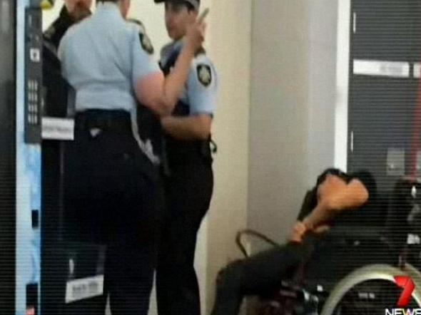 Grant Hackett slumped in a wheelchair after the flight from Adelaide to Melbourne.