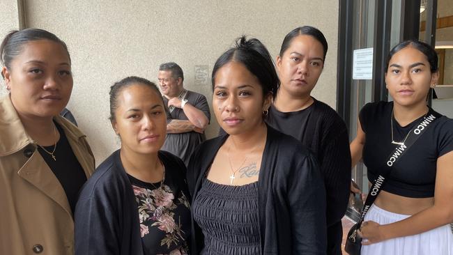 Rawinia Te Moni (centre) is surrounded by members of her family as they leave court.