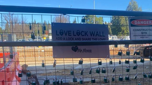 Outside Mooseheads, the Love Lock Wall is framed by construction activity in London Circuit Civic, Canberra. Image by Hannah Farrow