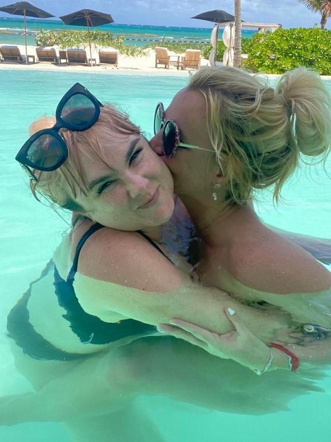 In one photo, Britney had her legs around her assistant, admitting in the caption she was naked at the time.