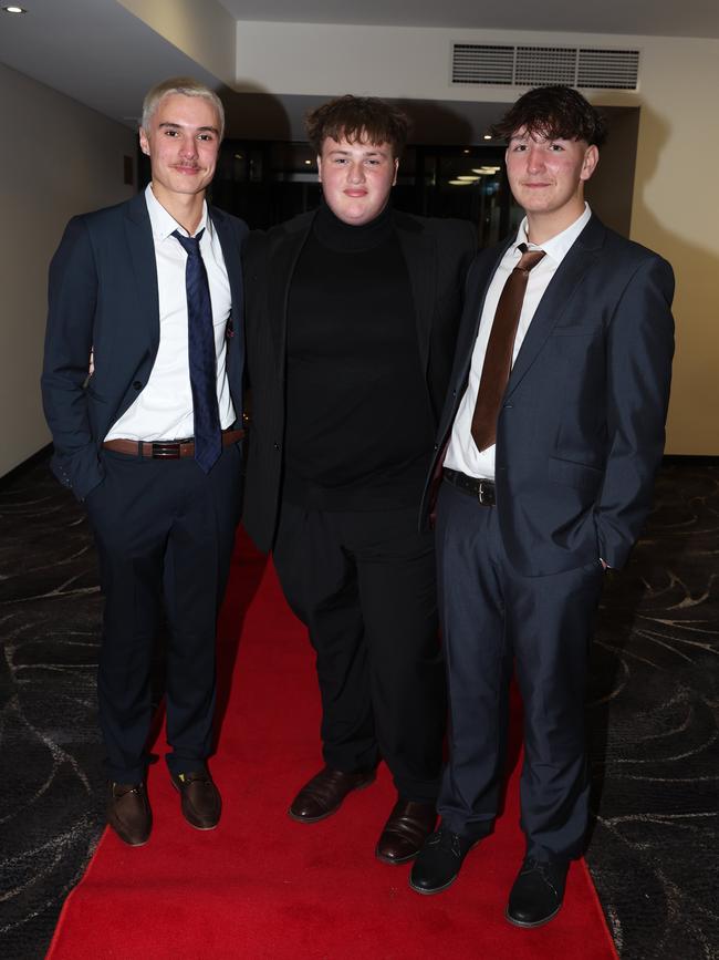 MELBOURNE, AUSTRALIA – JUNE 14 2024 Steven Kippen, Wyatt Debono and Brody Flynn attend the Lowanna College Senior Formal 2024 at the Moe Racing Club Picture: Brendan Beckett