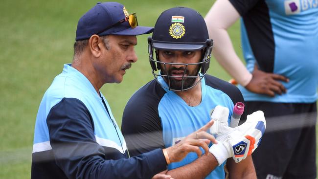 India's Rohit Sharma (right) chats with team coach Ravi Shastri during a training session at the MCG on Saturday ahead of the Third Test in Sydney on January 7. Picture: William West/AFP