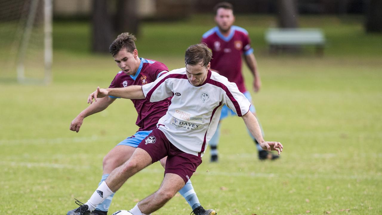 Matt Carey (front) for Warwick Wolves and Brandon Walker of St Albans in Toowoomba Football League Premier Men round eight at Middle Ridge Park, Sunday, May 9, 2021. Picture: Kevin Farmer