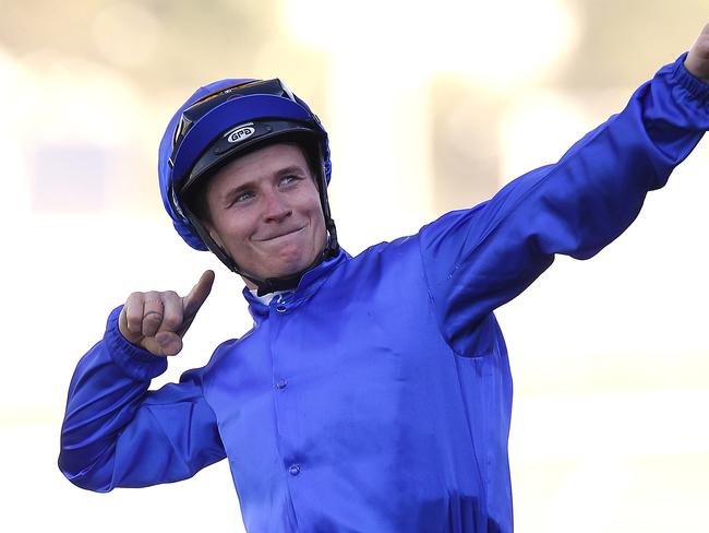 Jockey James McDonald riding Hartnell gestures to the crowd after winning The BMW race during the Western Sydney Legends Day at Rosehill race course in NSW. Saturday March 28, 2015. (AAP Image/David Moir) NO ARCHIVING, EDITORIAL USE ONLY