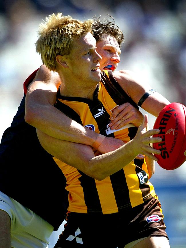 Sam Mitchell gets wrapped up during a game in 2004.