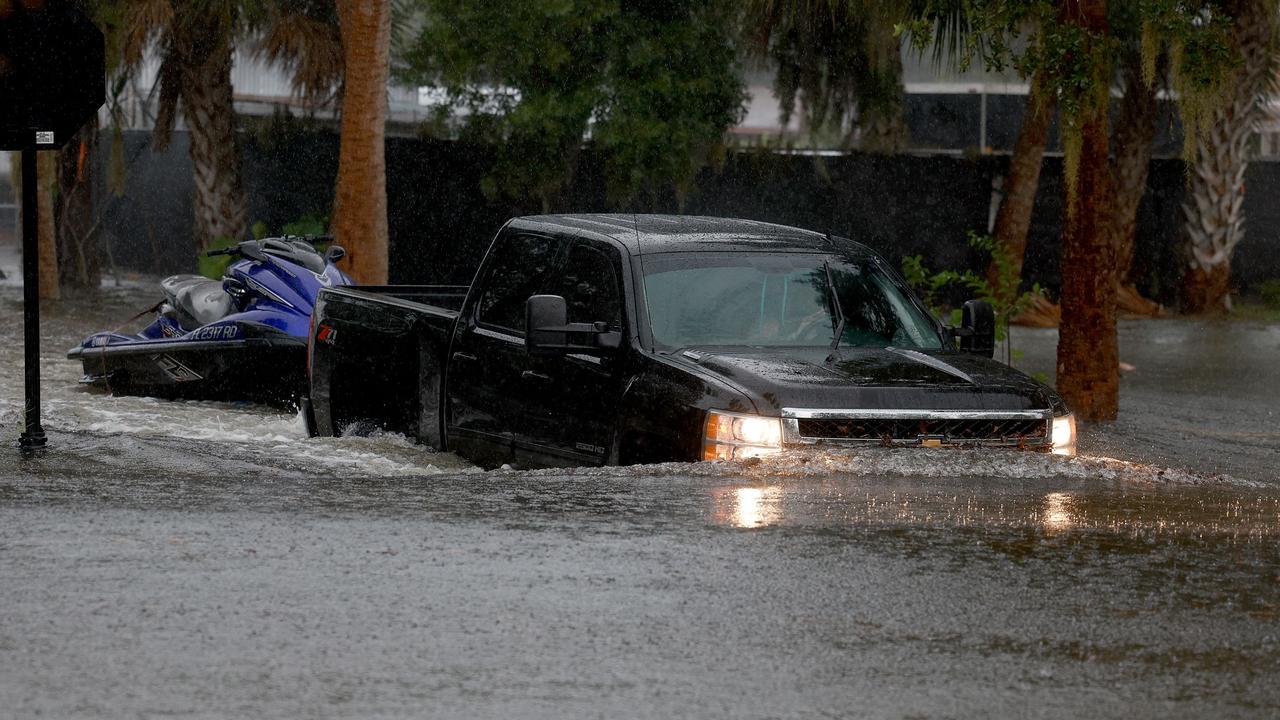A truck passes through flooded streets caused by Hurricane Idalia passing offshore on August 30, 2023 in Tarpon Springs, Florida. (Photo by JOE RAEDLE / GETTY IMAGES NORTH AMERICA / Getty Images via AFP)