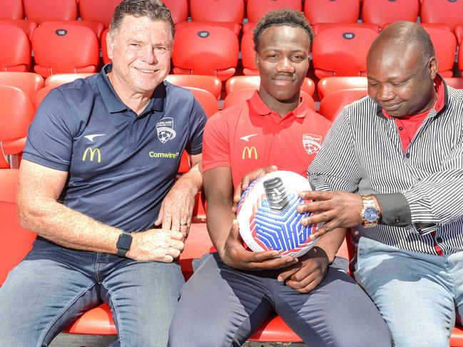 ADELAIDE, AUSTRALIA - NewsWire Photos November 15, 2023: Adelaide United coach Carl Veart, left, teenage superstar Nestory Irankunda and his dad Gideon at Coopers Stadium. Nestory has been signed to FC Bayern Munchen for a Club record fee. Picture: Newswire / Brenton Edwards