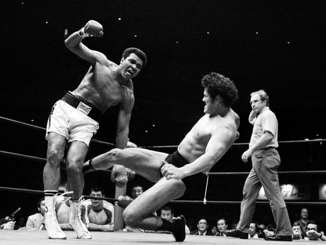 Japanese pro wrestler Antonio Inoki kicks the back of Muhammad Ali's leg in an attempt to trip him down on the mat during their boxing wrestling bout on June 26, 1976 at the Budokan Hall in Tokyo. Inoki challenged the World Heavyweight boxing champion in a 15-round fight billed as 