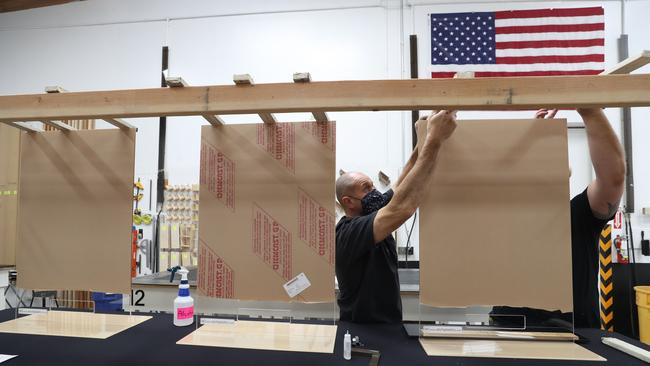 Acrylic sheets that will be used as social distancing guards are assembled for businesses in Petaluma, California. Picture: Getty Images