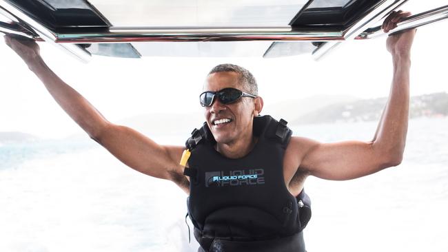 Former President Barack Obama takes a break from learning to kitesurf at Richard Branson's Necker Island retreat in the British Virgin Islands. Picture: Jack Brockway/Getty Images