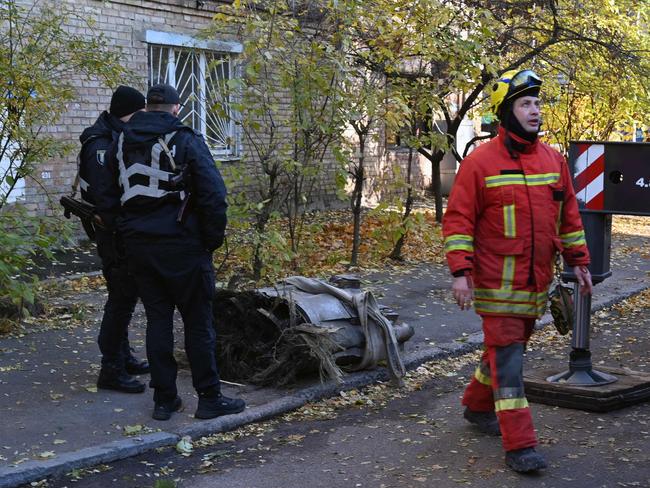 Police officers secure a large fragment of a downed Russian hypersonic missile Zircon, after it struck a five-storey residential building in Kyiv. Picture: AFP